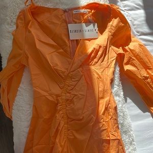 Saints + secrets orange dress